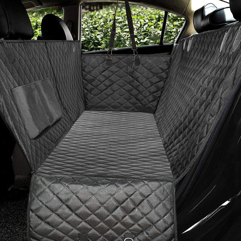 Dog sitting in car seat hammock cover with mesh window