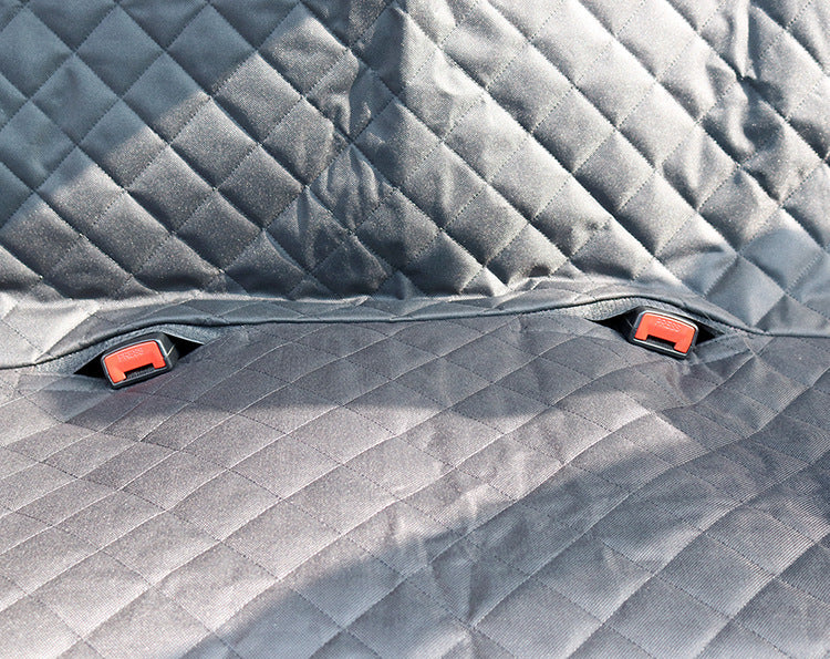 Dog sitting in car seat hammock cover with mesh window