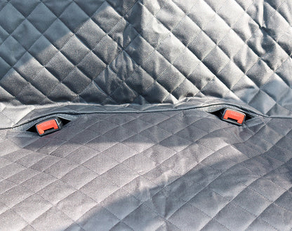 Dog sitting in car seat hammock cover with mesh window